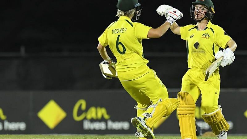Beth Mooney leads Australia's win over India in last-ball thriller.